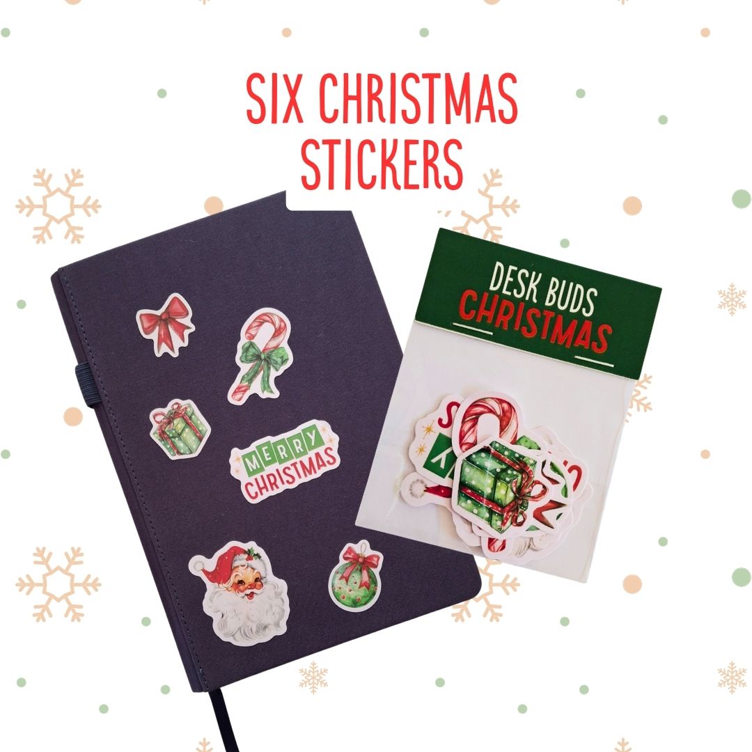 Six Christmas-themed desk stickers displayed on a dark notebook and a retail card labelled 'Desk Buds Christmas' on a white background with snowflake decorations.