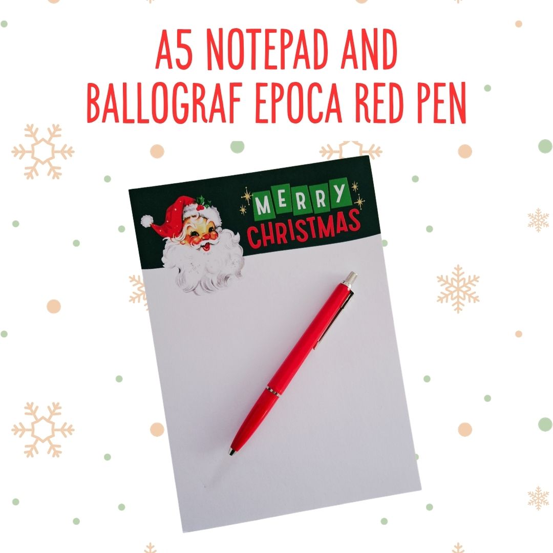 An A5 notepad with a Christmas Santa graphic and 'MERRY CHRISTMAS' header, paired with a red pen, shown on a white background with decorative snowflakes and the text 'A5 NOTEPAD AND BALLOGRAF EPOCA RED PEN'.
